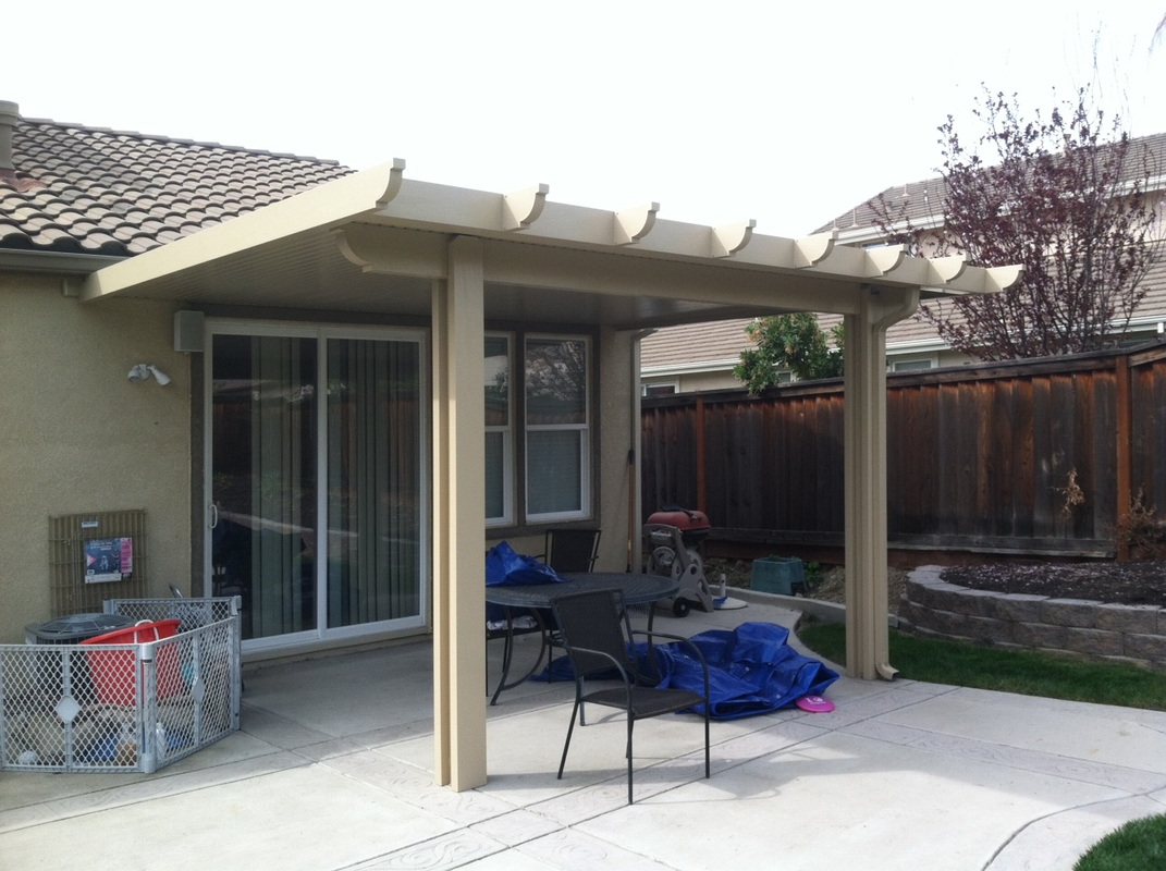 Freestanding patio cover with concrete slab and rear fence