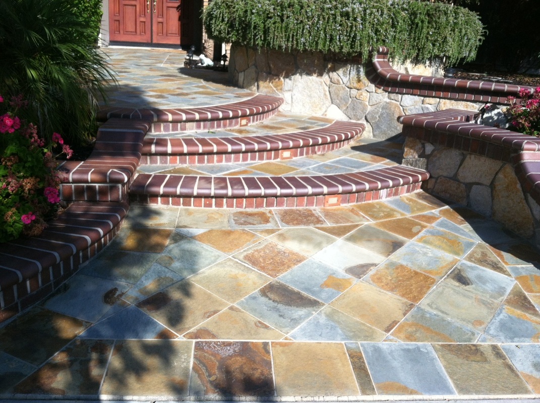 Flagstone entry with curved brick steps and stone wall
